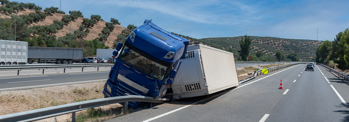 Truck with an accident refrigerated semi-trailer, overturned by the exit of the highway