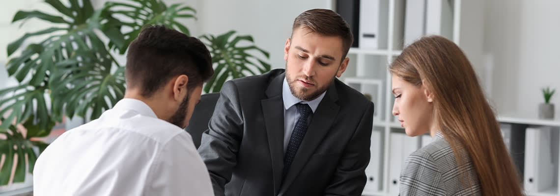 Unhappy couple visiting divorce lawyer