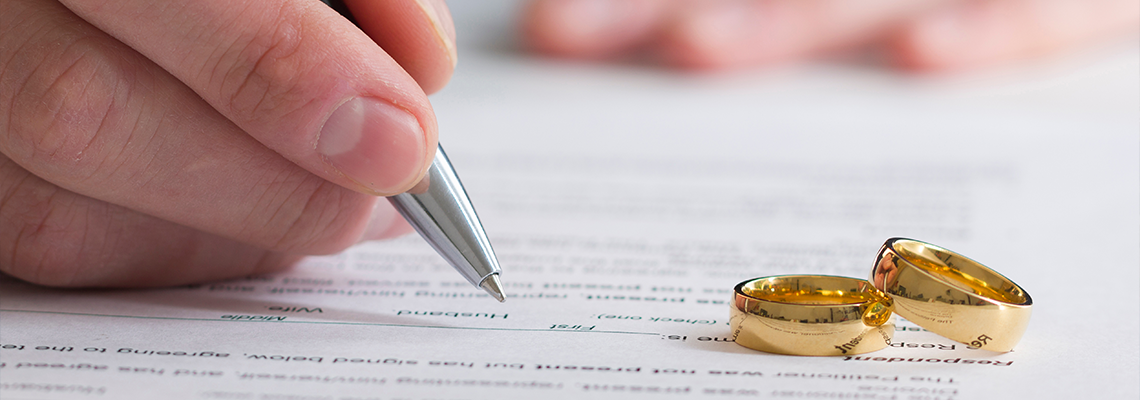 Hands of wife, husband signing decree of divorce, dissolution, canceling marriage