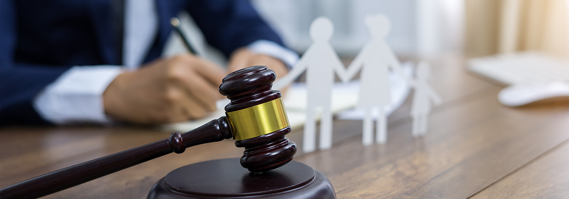 Family figure and gavel on lawyer's table