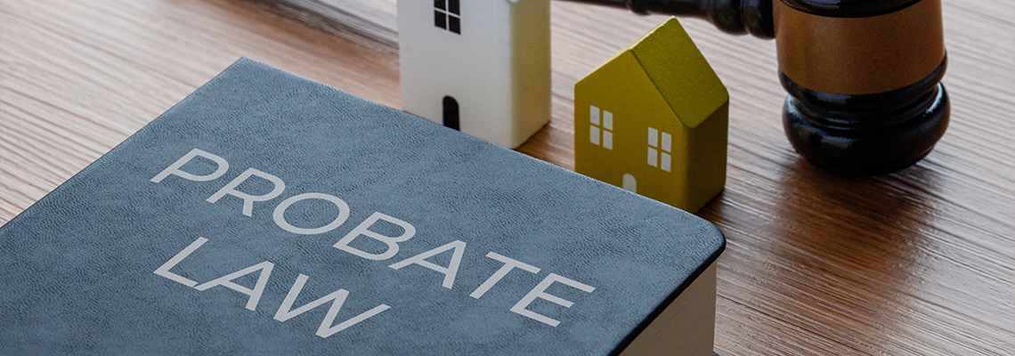 Miniature houses, judge's gavel and a PROBATE LAW book