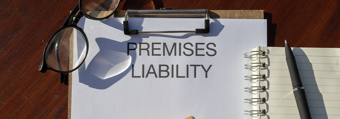 A legal document titled “Premises Liability” placed in a clipboard resting on the desk