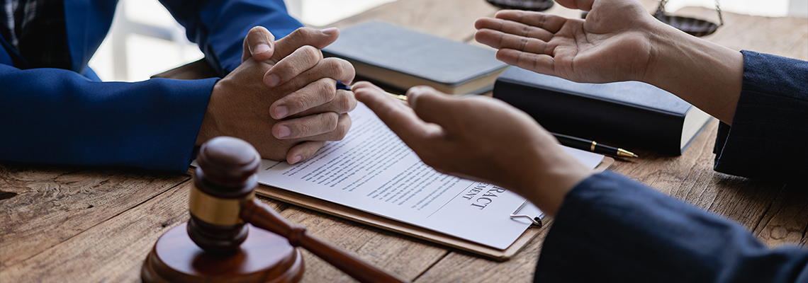 Male lawyer or judge consulting in team meeting with client