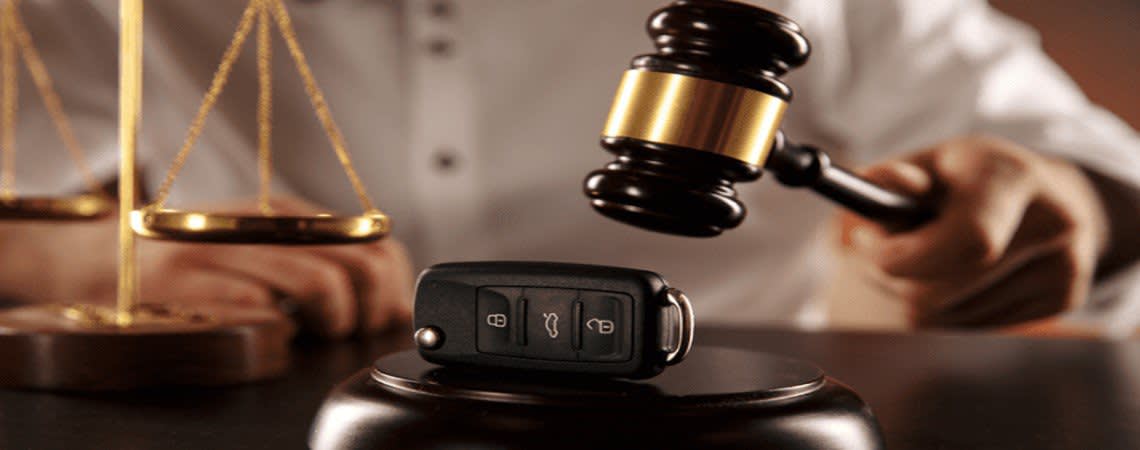 A gavel being brought down on electronic car keys