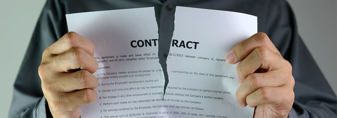 Man tearing contract paper