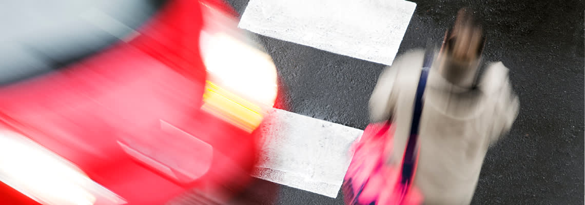 Car about to collide with pedestrian in crossing