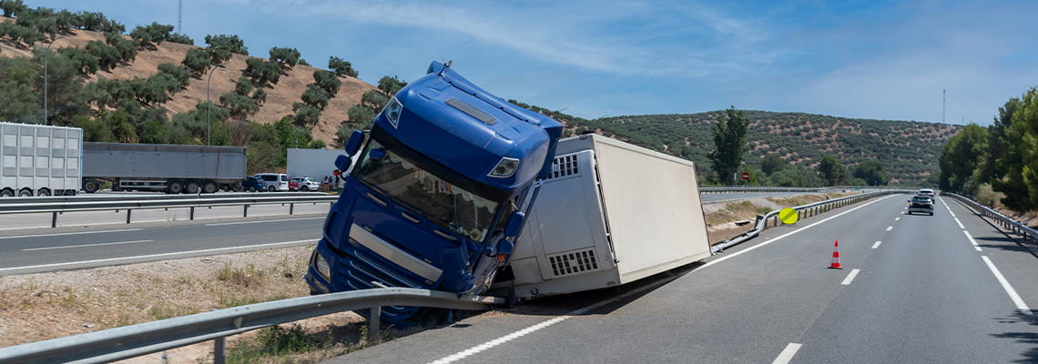 Truck with an accident refrigerated semi-trailer, overturned by the exit of the highway