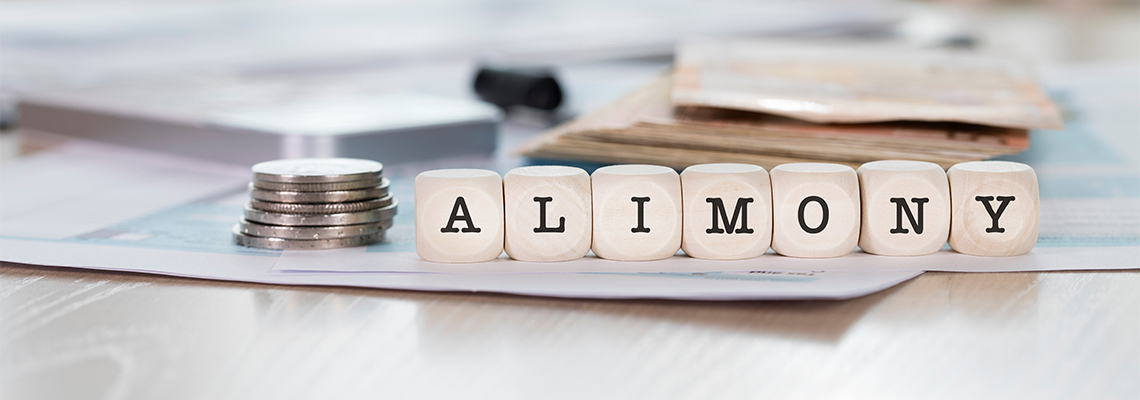 Word ALIMONY composed of wooden letters and coins