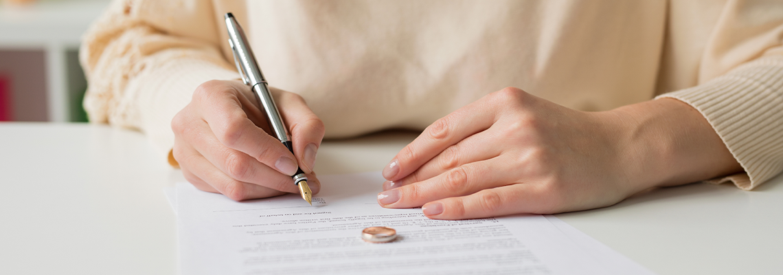 Woman going through divorce and signing papers