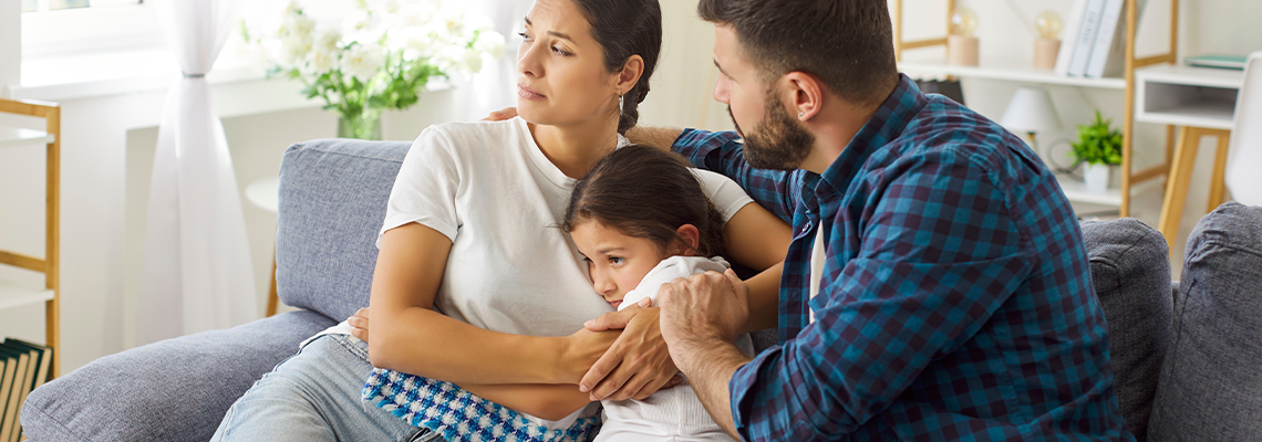 Mother and father provide steady support and care on the sofa