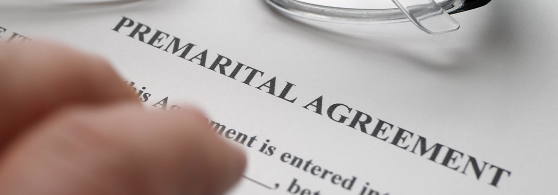 Finger tapping on premarital agreement form