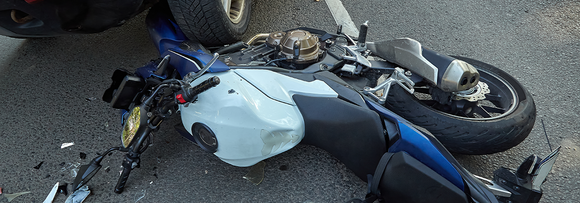 Damaged motobike and a car in a accident