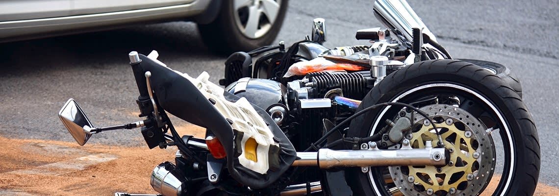 Wrecked motorcycle lying on its side