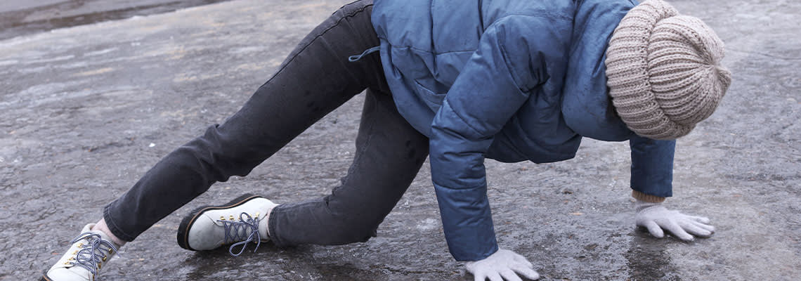 Women slip and fall on icy pavement