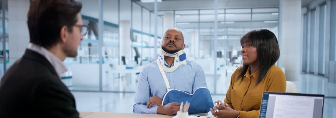 Injured person and his wife consulting with an attorney