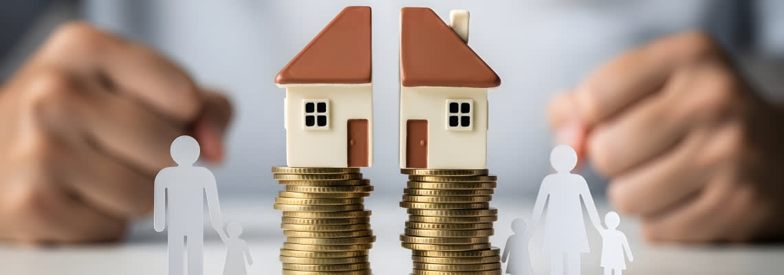 House model, coin stacks and paper family showing asset division