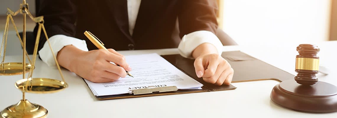 A person signs a document