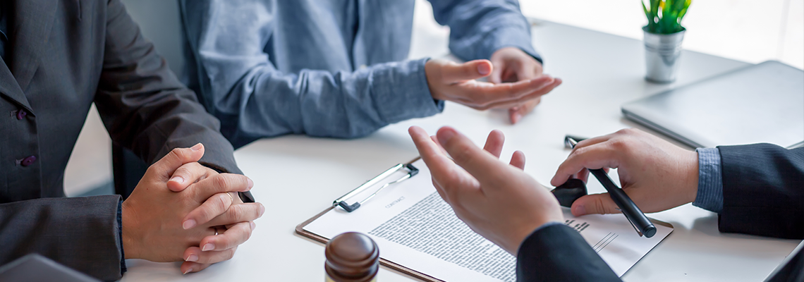 Businessman and lawyer discuss the contract document