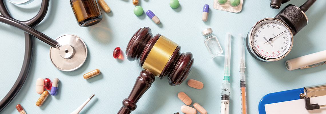 Judge gavel, medical stethoscope and medicine