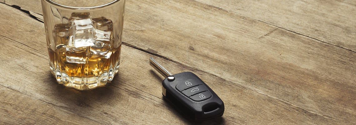 Glass of Whiskey next to keys