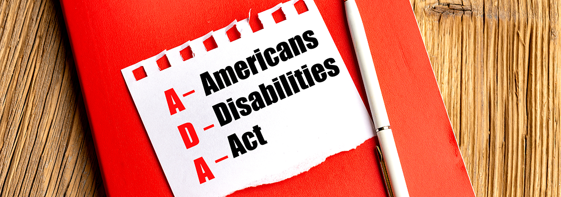 Americans with Disabilities Act text on torn paper placed on red notebook