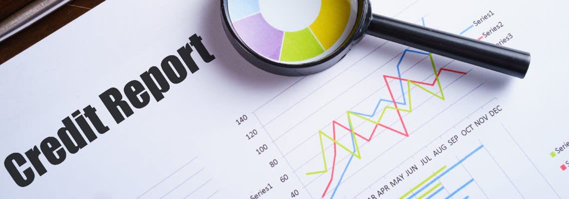 Credit Report with graphs and a magnifying glass