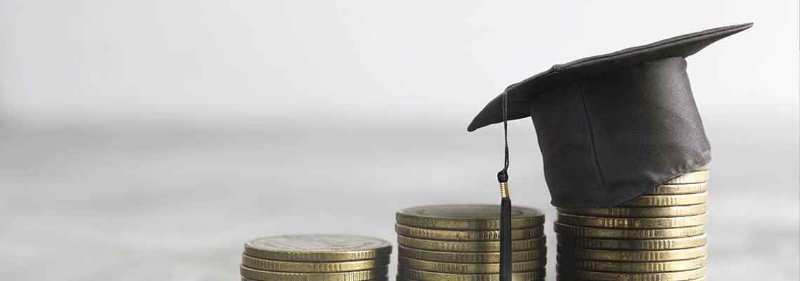 Grad cap sitting on a stack of coins