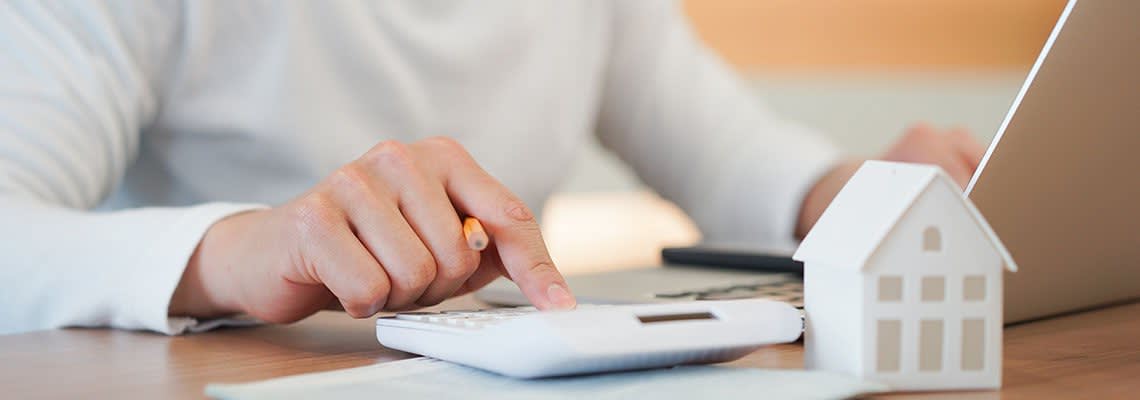 Man working on mortgage documents on a computer
