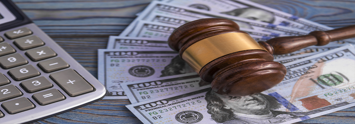 The judge's gavel, calculator, banknotes of American dollars on the background of wooden table. business, Finance. corruption.