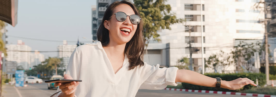 Person smiling and holding hand out to street