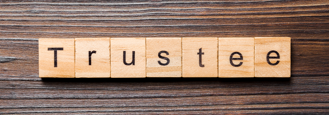 Trustee word written on wood block. trustee text on table