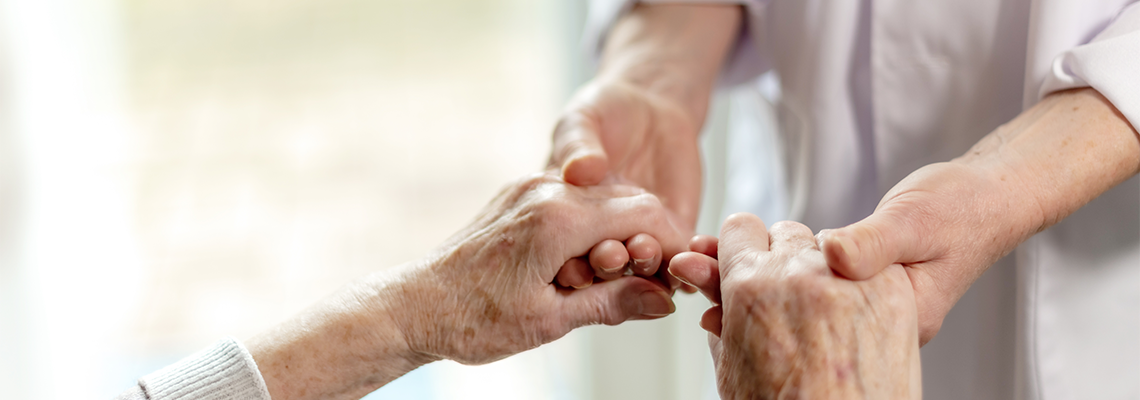 Person holding hands of an old man