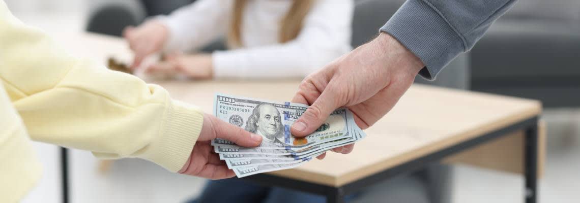 Man giving Alimony money to ex wife