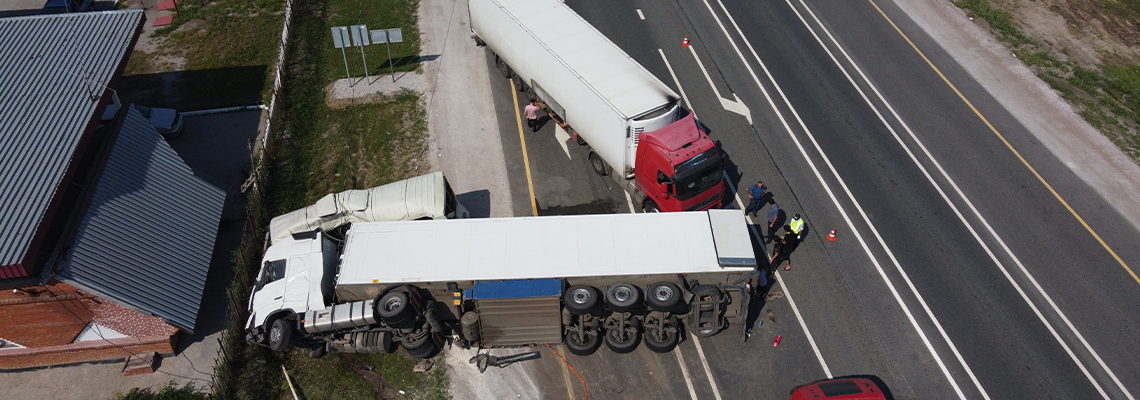 Top view of a car accident involving a truck and a bus