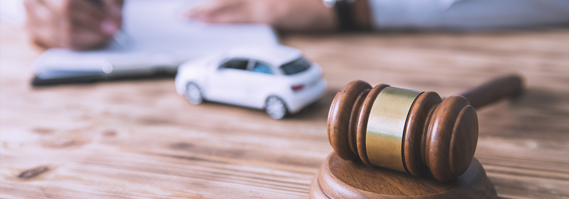 Man hand car model with document and gavel