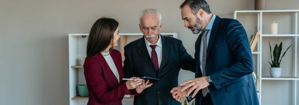 Senior Businessman with Son and Daughter in Modern Office