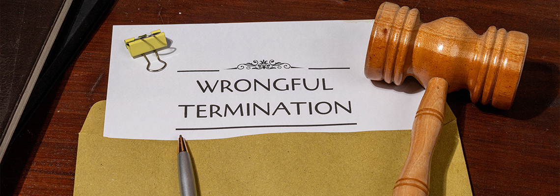 Document Detailing Wrongful Termination on Table with Gavel