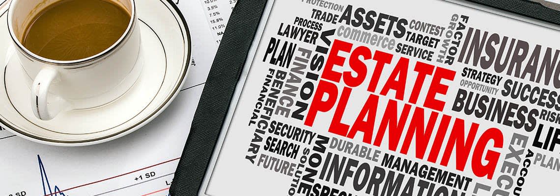 Estate planning words on a tablet next to a cup of coffee