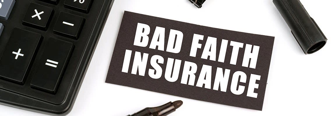 A Bad Faith Insurance card next to a calculator