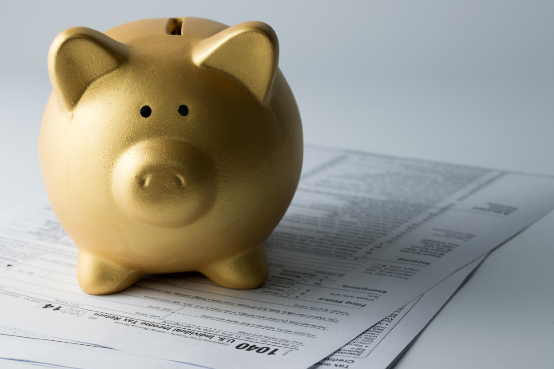 Small piggy bank on documents