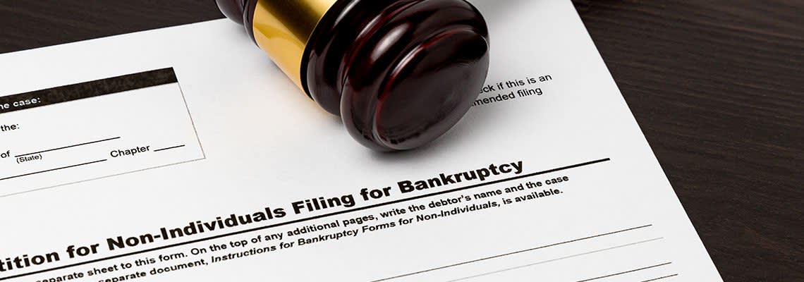 Gavel resting on a document to file bankruptcy