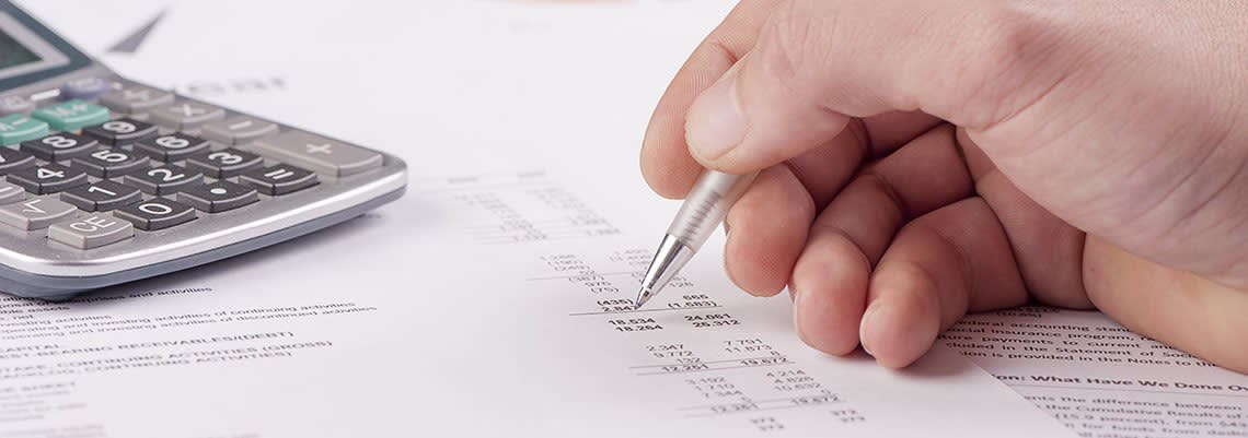 Filling out tax documents with a calculator