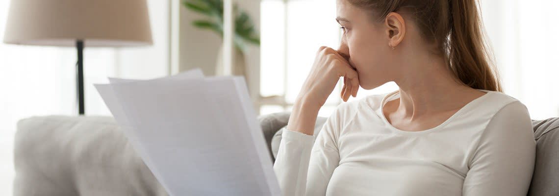 Frustrated woman with documents in her hands