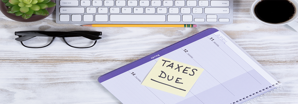 Tax season with supplies on wooden desktop