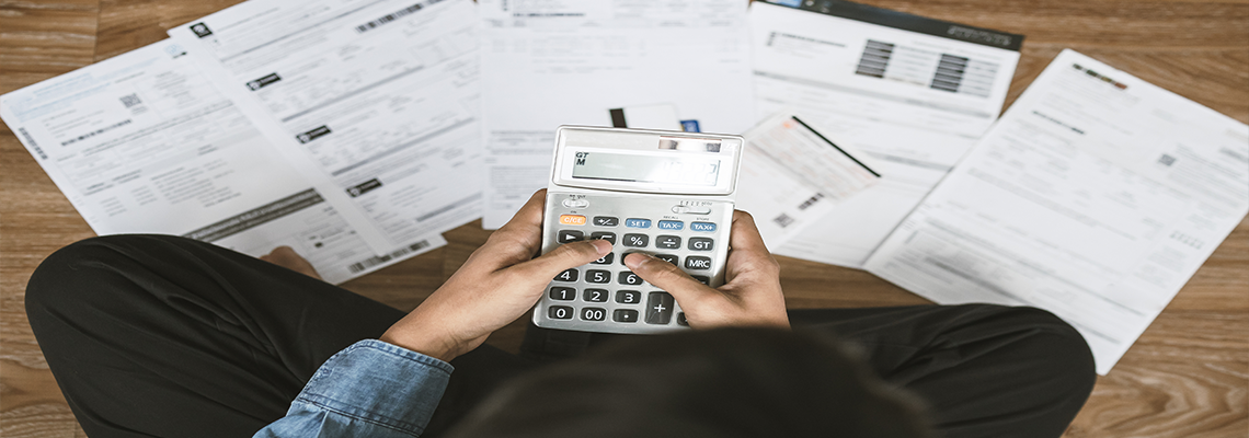 Top view man sitting on the floor stressed and confused by calculate expense from invoice or bill.
