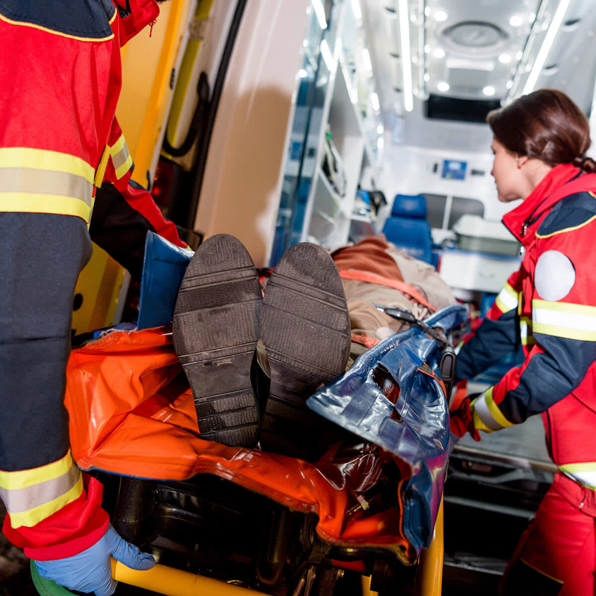 Paramedics helping someone get in ambulance