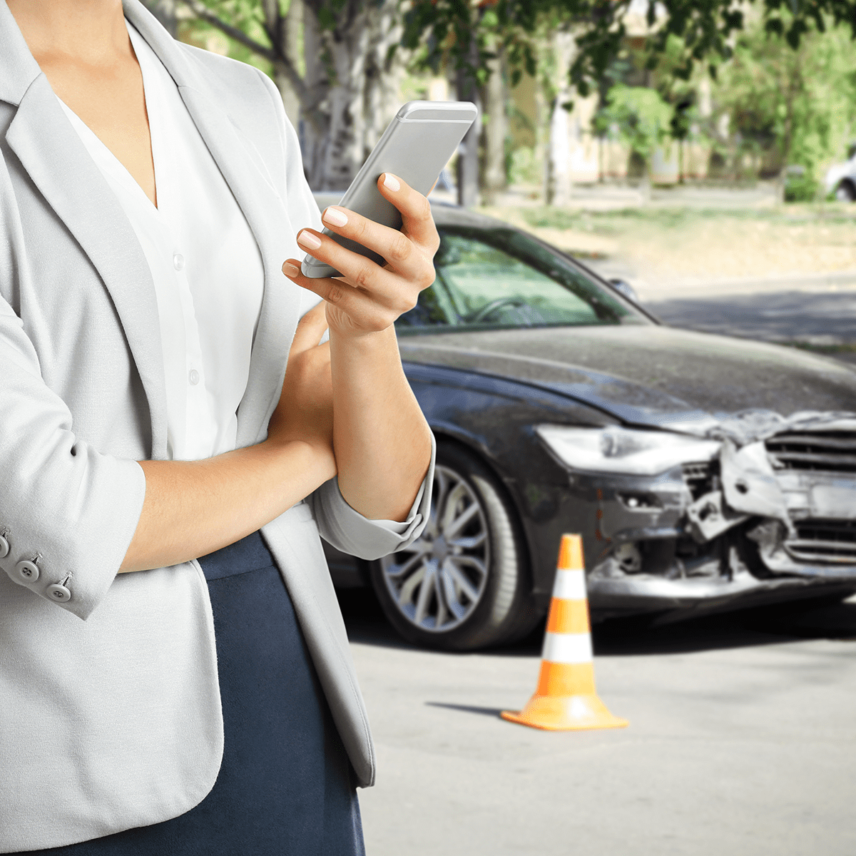 Woman using phone after car accident