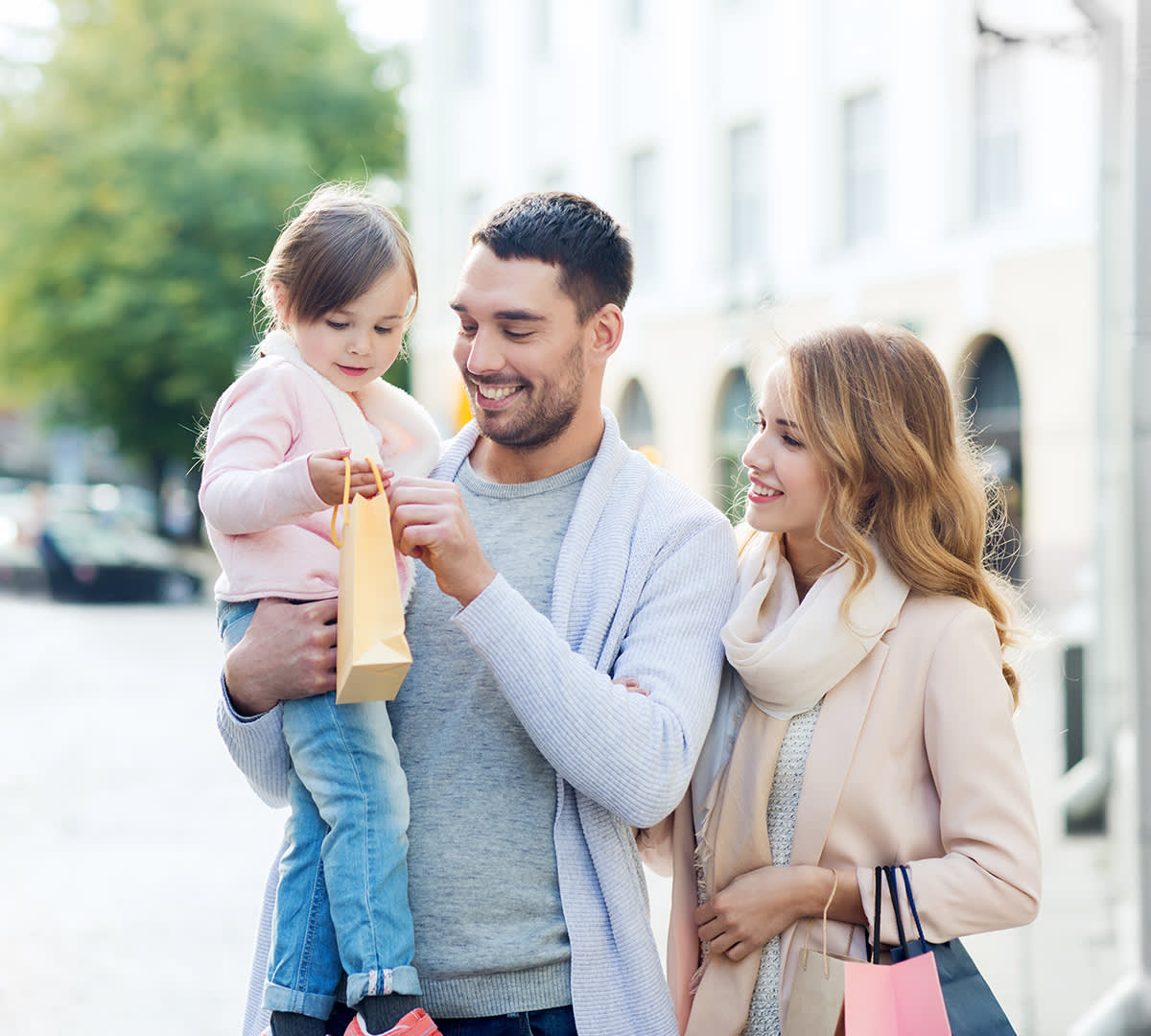Happy family with shopping bags in the city
