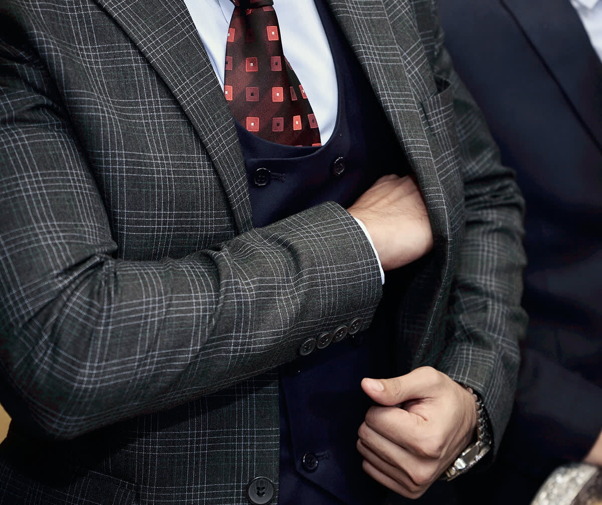 Businessman reaching into his suit jacket pocket