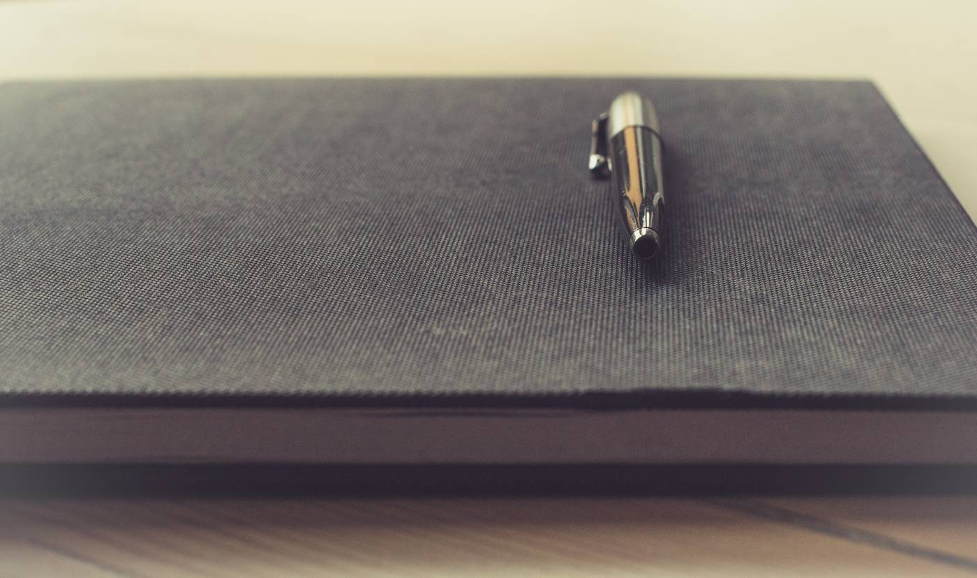 Pen resting on notebook